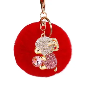 Cute rhinestone sheep plush pom-pom keychain, stylish red fluffy ball with gold metal keyring.