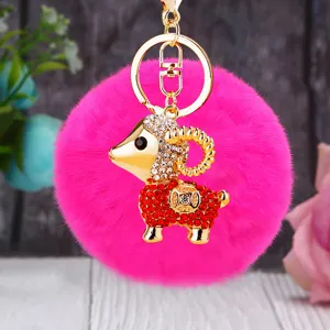 Cute rhinestone ram plush pom pom keychain accessory detail view, fluffy charm bag pendant.