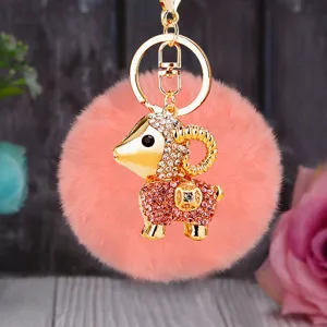 Fluffy pink pom pom keychain with rhinestone gold ram pendant, cute bag charm accessory