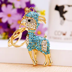 Rhinestone little goat metal keychain bag pendant, sparkling blue white crystal animal design.