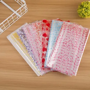 Transparent printed plastic gift bags with cute heart patterns for toys and packaging.