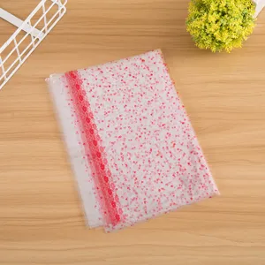 Transparent plastic gift packaging bag featuring red heart and floral prints for toys.
