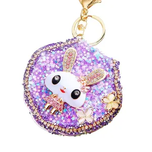 Detailed view of the sparkling rhinestone purple rabbit keychain pocket mirror for cute bags and keys.