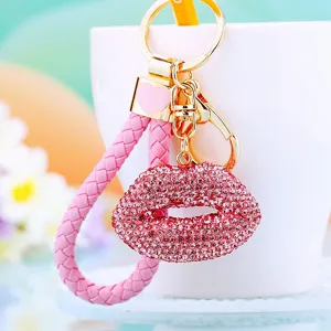Detailed shot of sparkling pink rhinestone lips keychain with braided strap, perfect bag charm.