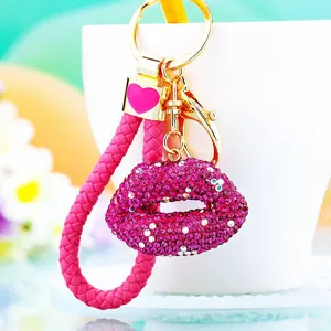Sparkling crystal rhinestone lips keychain with metal ring and pink woven rope pendant.