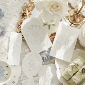 Detailed view of white lily of the valley greeting cards, floral packaging inserts and decor.