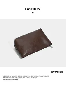 Detailed view of the brown faux leather cosmetic pouch with smooth zipper and clean finish.