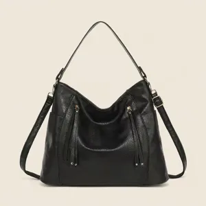 Detailed close-up of a black PU leather hobo shoulder bag featuring vertical front zipper pockets.