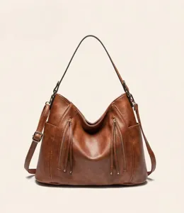 Detailed view of brown PU leather hobo shoulder bag with stylish front tassel zippers.