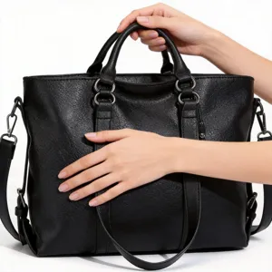 Black soft leather handbag detail, stylish shoulder tote bag with double top handles.
