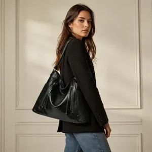 Detail view of the elegant black shoulder hobo bag worn by model, showcasing large capacity.