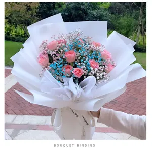 Beautiful pink roses bouquet with white wrapping paper and ribbon gift for special occasions.