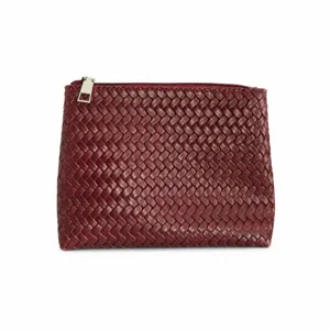 Burgundy woven leather pouch detail closeup, premium texture zipper clutch bag for women.