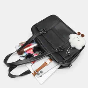 Black PU leather Japanese style JK uniform bag detail showing large capacity, cute cloud pendant and straps.