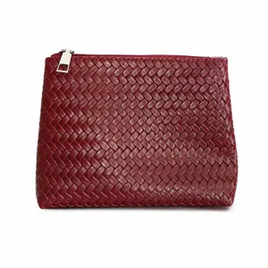 Burgundy woven leather pouch detail, classic intrecciato texture, premium metal zipper.