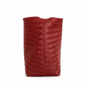 Red woven leather handbag bucket bag detail showcasing premium artisanal craftsmanship and texture.