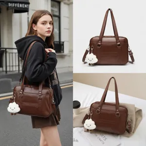 Brown PU leather JK uniform shoulder bag with cute cloud pendant, detailed lifestyle view.