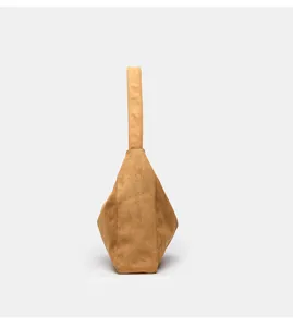 Detailed side view of brown suede hobo shoulder bag, showing retro minimalist underarm design.