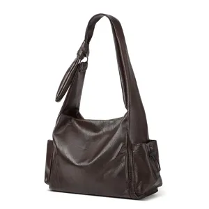 Detailed view of the dark brown hobo shoulder bag with stylish slouchy design and side pockets.