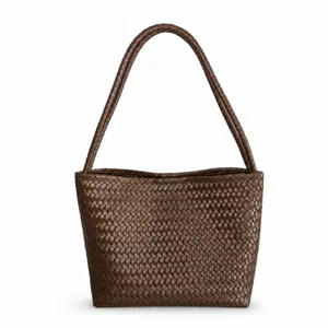 Brown woven leather shoulder bag detail, showcasing elegant texture and classic design.
