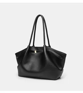 Strukturierte Details der schwarzen Ledertasche mit Flügeldesign und elegantem Metallverschluss.