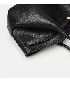 Detailansicht der schwarzen Handtasche aus Narbenleder mit klassischer Metallbeschlag.