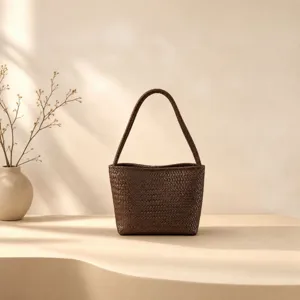 Close up view of the dark brown woven leather handbag detail, showing exquisite craftsmanship.