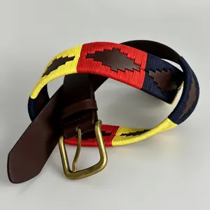 Close-up detail of a handmade equestrian embroidered woven belt with genuine leather and buckle.