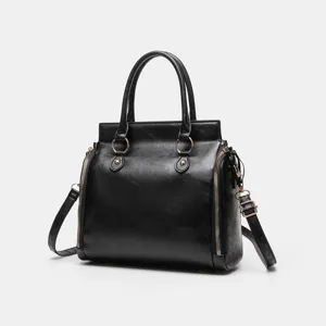 Élégant sac à main pour femme en cuir PU noir avec poignées doubles et fermetures éclair latérales.