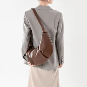 Detailed view of the soft leather pleated croissant crossbody bag in brown, stylish everyday wear.