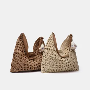 Detailansicht der sommerlichen Strohtasche, handgefertigt mit süßem Plüschschaf-Anhänger.