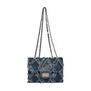 Denim chain shoulder bag for women, quilted cross-body handbag with frayed trim.