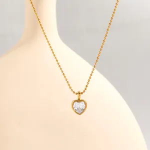 Gold bead chain necklace featuring a delicate heart crystal pendant for daily women fashion style.