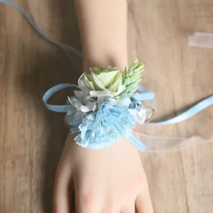 Detailed close-up shot of forest style artificial blue carnation wrist flower accessory.