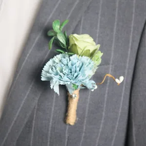 Artificial flower boutonniere detail shot, blue carnation and green rose wedding corsage.