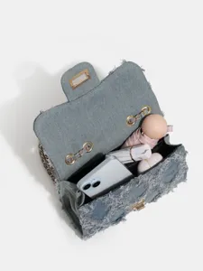 Denim chain crossbody bag for women, chic patchwork flap shoulder bag with spacious interior.