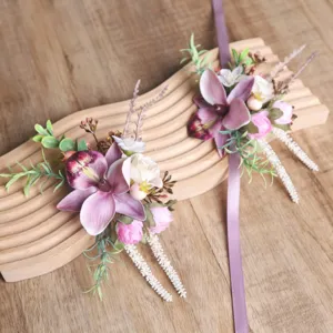 Exquisite artificial orchid wrist flower detail, pink and purple wedding floral design prop.