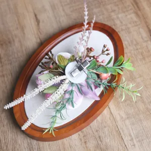 Forest style wedding floral corsage detail, pink and purple artificial flower with metal clip.