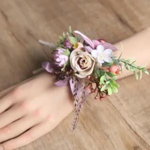Artificial wedding wrist flower corsage with pink roses, berries, and purple ribbon for brides.