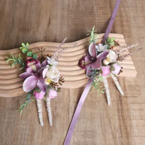 Detailed view of purple artificial flower wrist corsage set for wedding and party events.