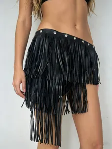 Black leather fringe waist belt with metal rivets, punk rock style detail view for women.