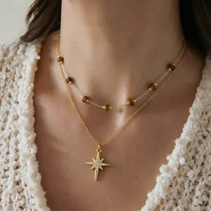 Delicate double layer stainless steel necklace with star pendant and chic beads.