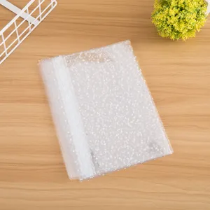 Transparent plastic gift bag detail, featuring delicate white lace trim and cute heart print.