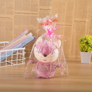 Clear printed transparent gift bag with cute plush toy doll, ideal for wrapping presents nicely.