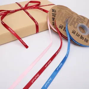 Floral gift wrapping satin ribbon rolls with English print for packaging and decoration.