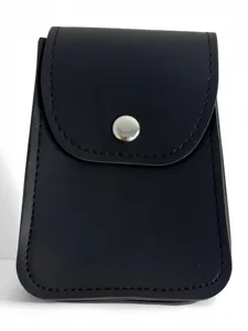 Detailed shot of dark faux leather small pouch with silver metal snap button closure.