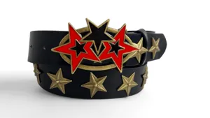 Detailed view of the punk style black leather belt with antique bronze and red star metal buckle.