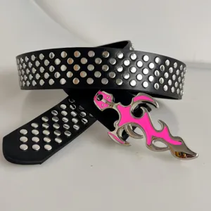 Black leather belt featuring multiple metal rivets and a striking pink dagger buckle for Y2K punk style.