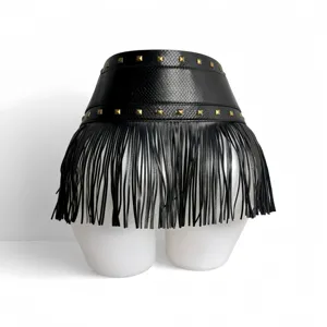 Detailed view of the black wide waist belt featuring pyramid studs and stylish long fringe.