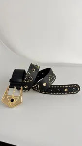 Detailed close-up view of a black leather punk style belt featuring gold studs and crystal stones.